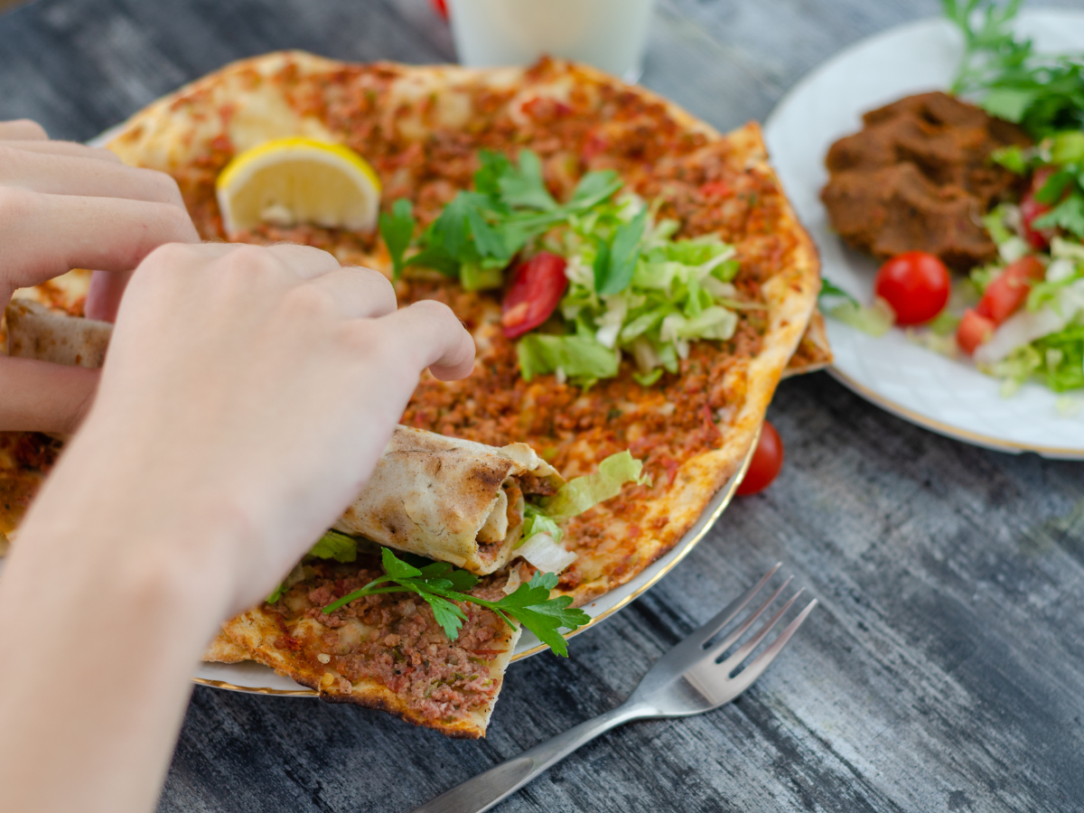 foods in turkey lahmacun with hand