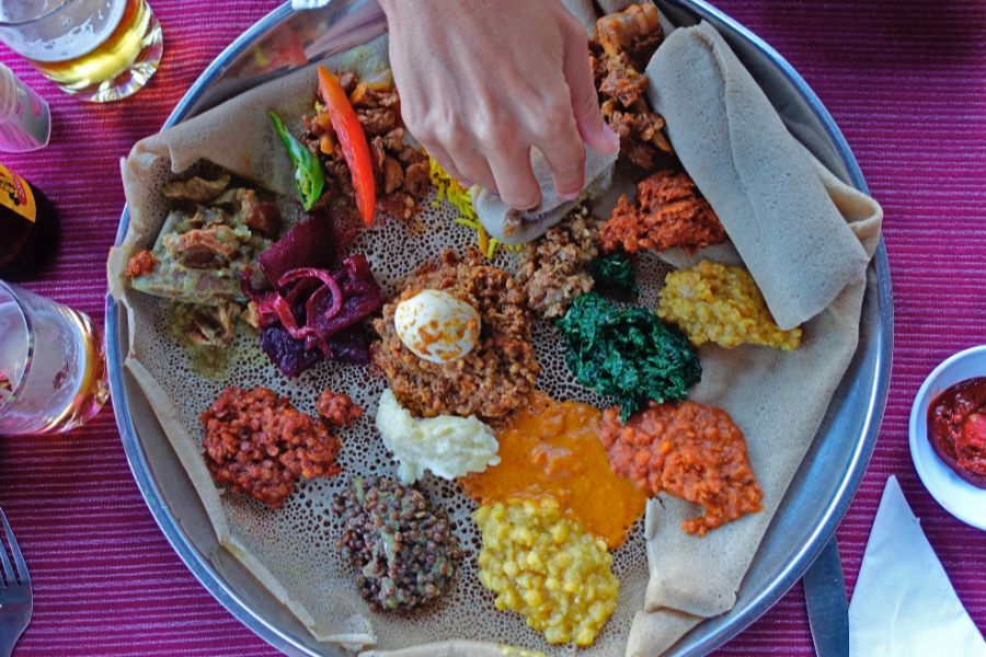 Foods From Ethiopia - Yetsom Beyanetu hand eating Featured