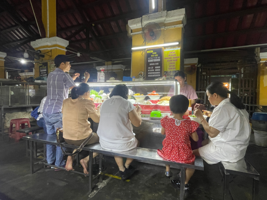 Locals eating Central Food Market Stall Hoi An