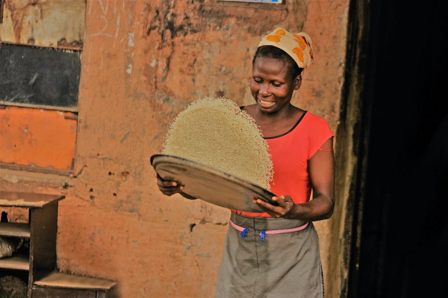 africa food map woman tossing grain