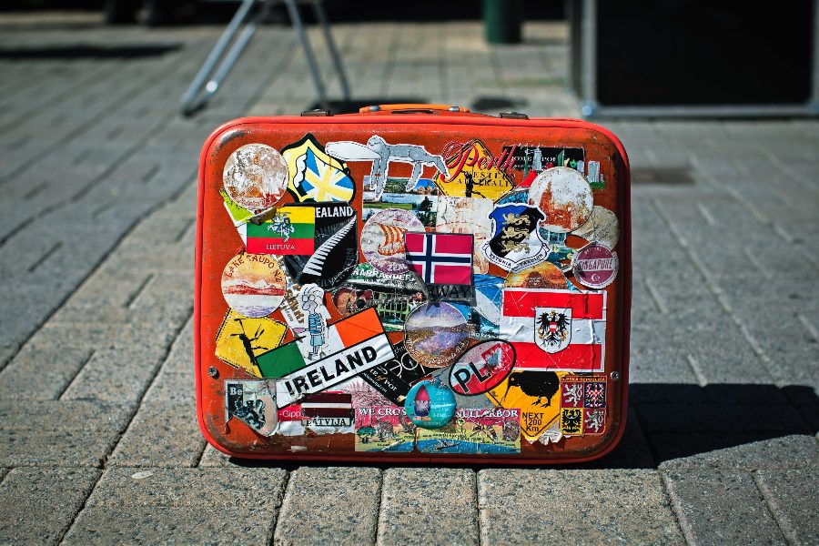 essential items for european travel packing list for europe suitcase with stickers