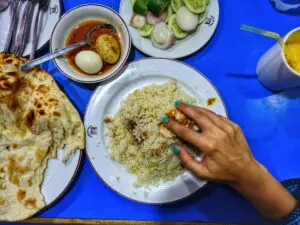 hand over rice curry and naan bread Bangladesh