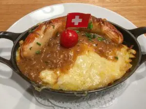 Swiss sausage rosti in pan with flag