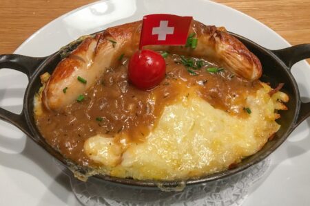 Swiss sausage rosti in pan with flag